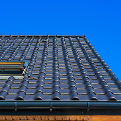 vertical-low-angle-closeup-shot-of-the-black-roof-of-a-building.5d6b7a034a730306cbdd84c8b738f0fa