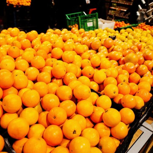 yellow-oranges-on-boxes-at-supermarket_627829-7291